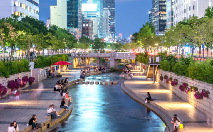 Evening calm at Cheonggyecheon Stream with city lights reflecting on water