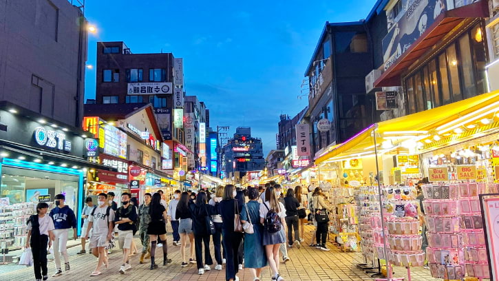 Nightfall over Hongdae street, a hub of neon-lit stores and the pulse of urban life in Seoul