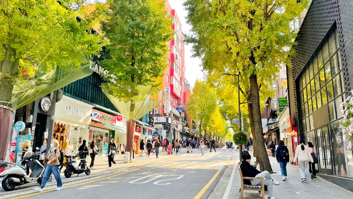 Shoppers stroll down the tree-lined Ewha Shopping Street