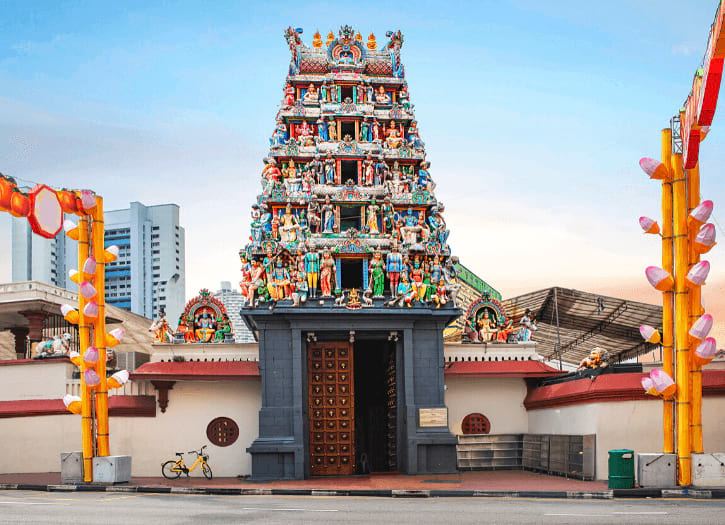 The Sri Mariamman Temple, featuring a vibrant gopuram adorned with colorful deity figures