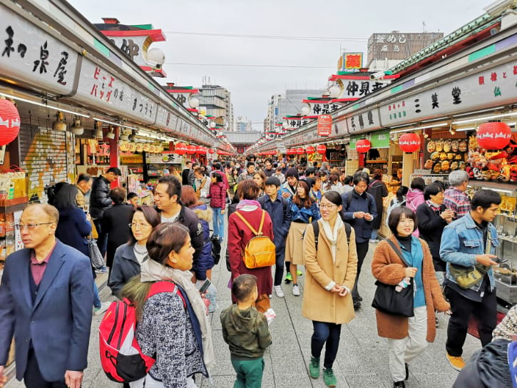 Nakamise Shopping Street with busy stalls selling Japanese souvenirs and snacks