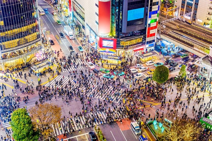 Busy Shibuya Crossing intersection with crowds of pedestrians crossing in multiple directions