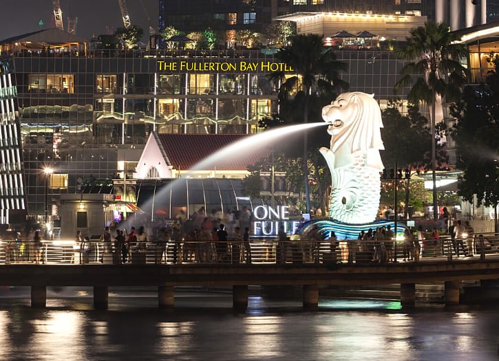 Merlion Statue, a symbol of Singapore, with its water jet set against the city's high-rise panorama