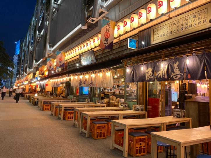 Shibuya Yokocho's vibrant alley, bustling with diverse and authentic Japanese cuisine