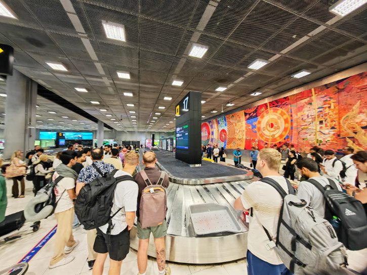 Travelers Queue Up to Collect Their Luggage
