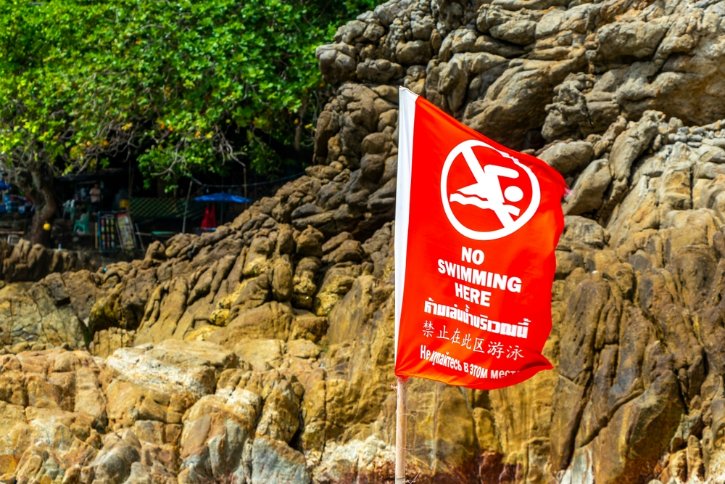 Patong Beach Bay with Red Flag Warning Sign
