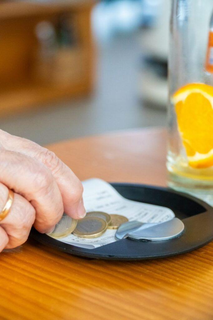 Leaving Coins On A Cafe Bill Tray