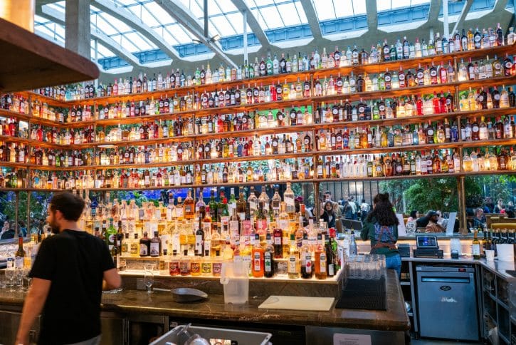 Bar Counter With Shelves Of Liquor Bottles