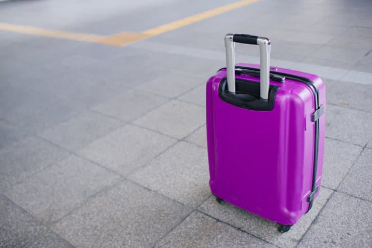 Purple Travel Suitcase On Pavement